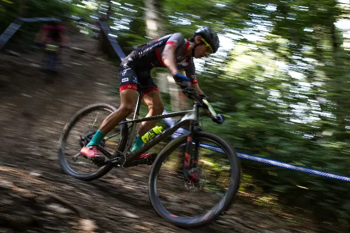 a man riding a bike down a dirt road